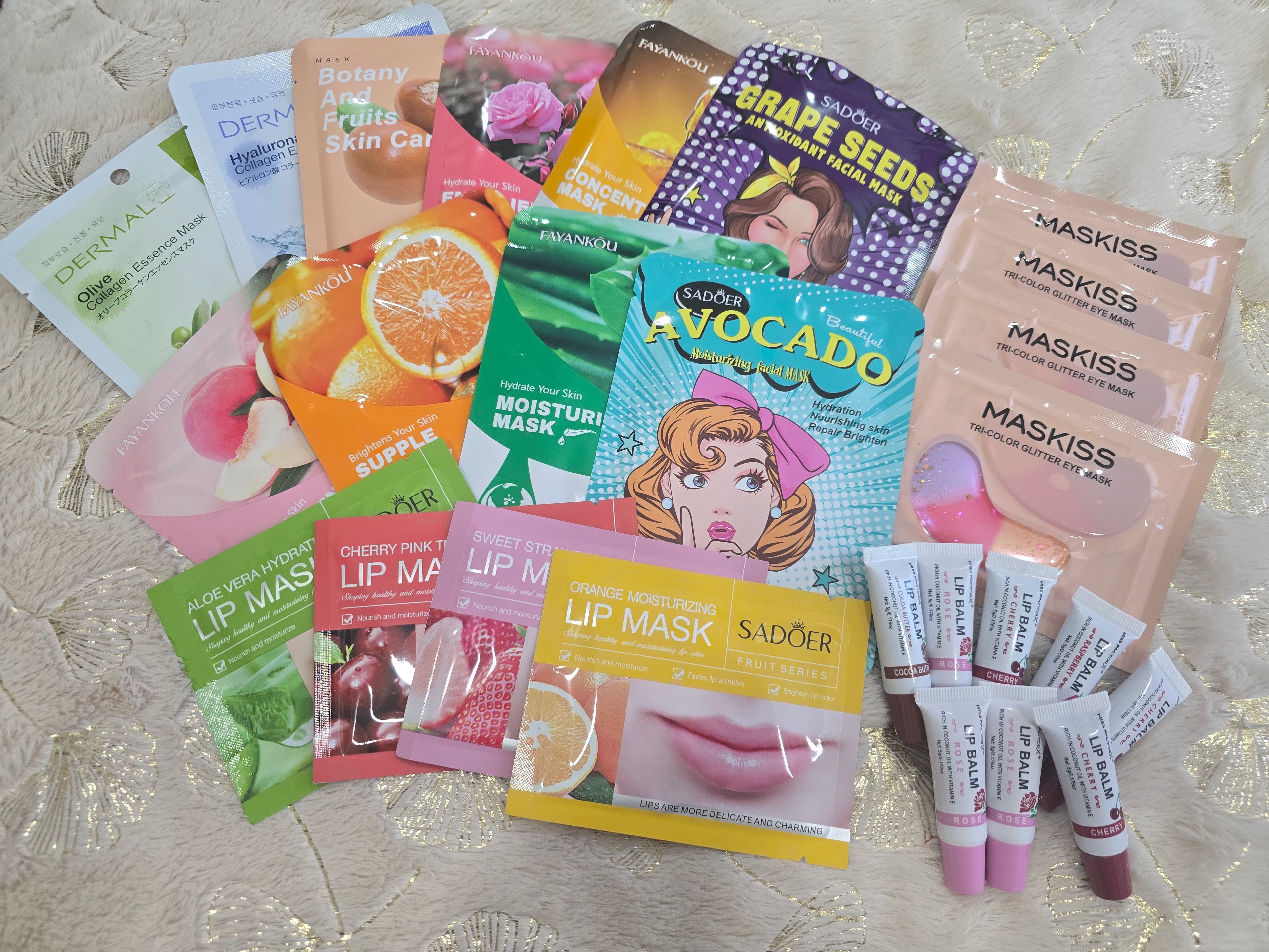 Collection of various skincare and lip mask packets on a textured surface